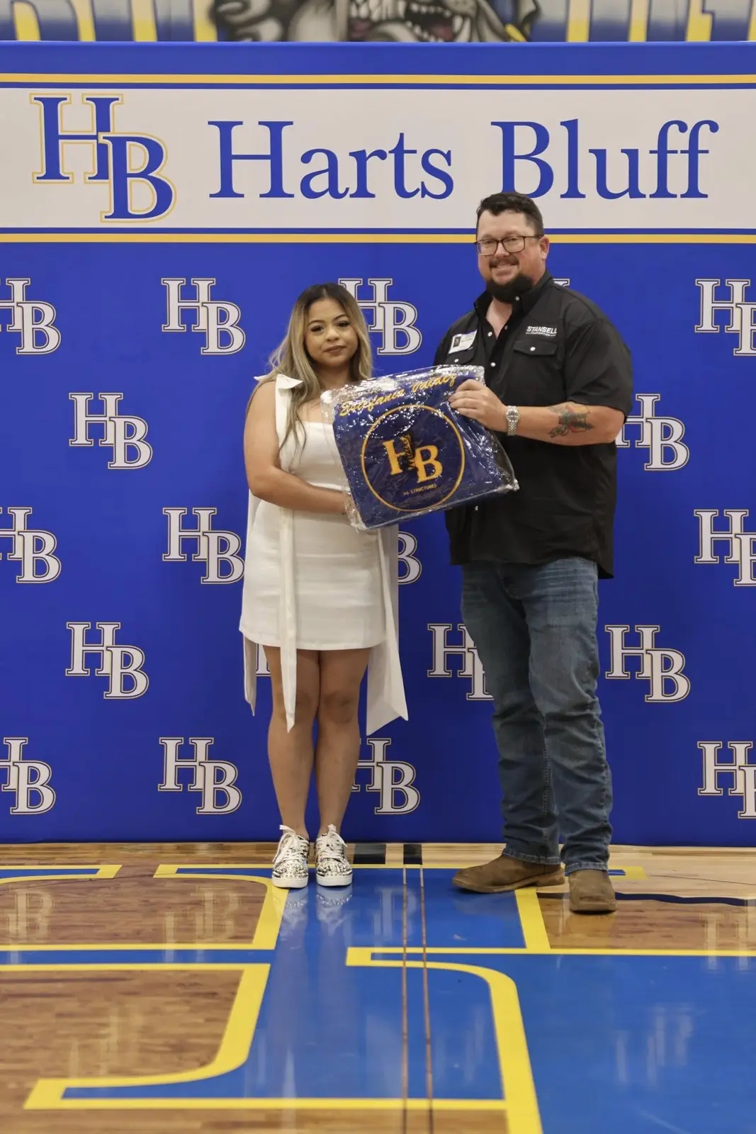 Stansell Construction presenting a graduation gift at Harts Bluff